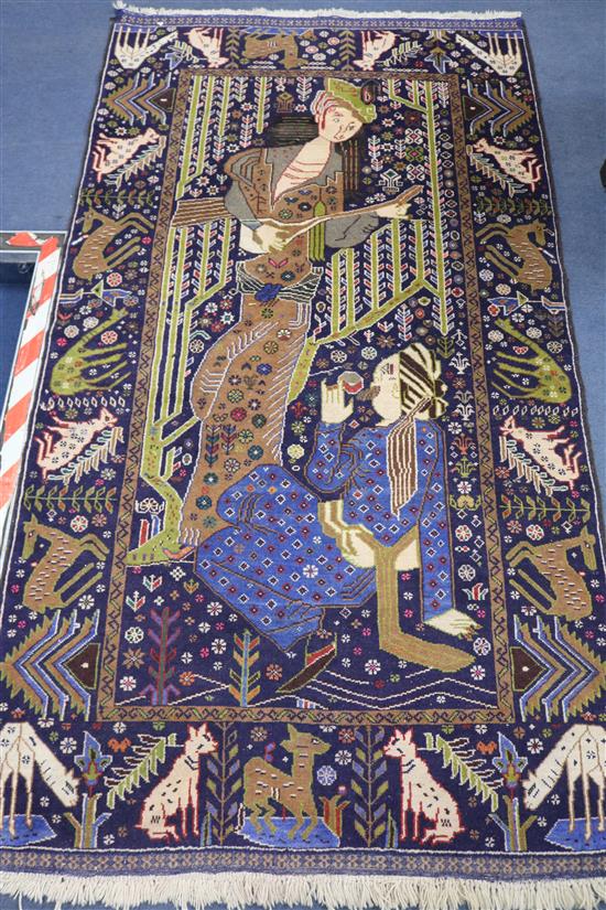 A Persian rug woven with two figures 203 x 114cm